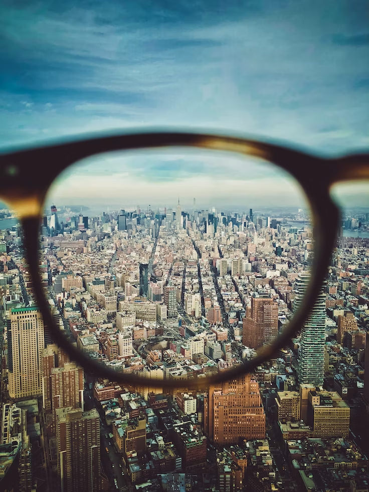 View looking out on a city but through a glasses lense